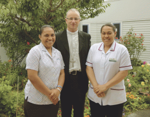 Srs Tematoro Uabong left, and Paea Tamale with Bishop Charles Drennan.